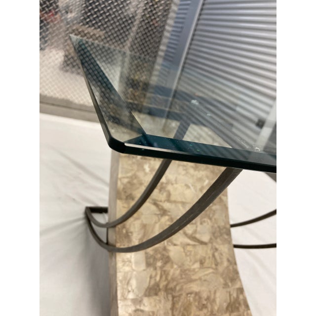 Vintage tessellated fossil sculptural side end table, having brass inlay, beveled glass top, hand wrought iron stabilizer,...