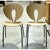 The chairs feature sculpted oak seats and backrests with a distinctive teardrop cutout that adds visual lightness to the...