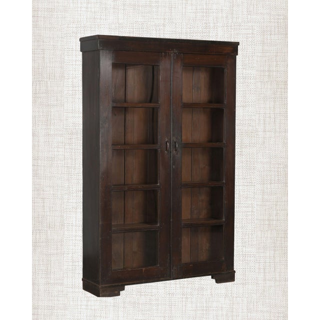 Dark as aged leather. Still as a room before dawn. This antique Indian Armoire in deep espresso teak is the rare piece...