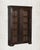 Dark as aged leather. Still as a room before dawn. This antique Indian Armoire in deep espresso teak is the rare piece...