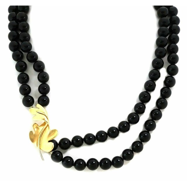 The Tiffany & Co. Onyx Beads 18k Yellow Gold Oak Leaf Enhancer Necklace is a stunning vintage piece from the fine jewelry...