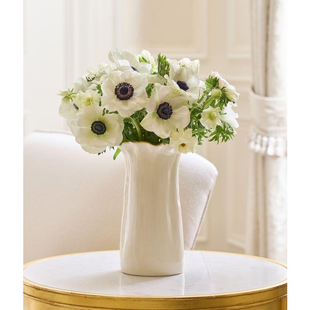 Crafted in Italy, this hand-built ceramic vase has a sculptural silhouette. The textured gold finish is enhanced by a...