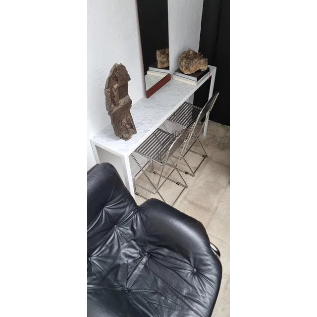 A stunning vintage armchair, often attributed to Marcel Breuer and dating back to the 1970s. The chair boasts a chromed...