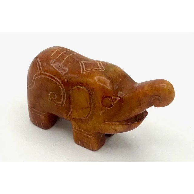 This small hand-carved Chinese jade or jadeite elephant weighing 5oz is a delicate piece of art. The Chinese have...