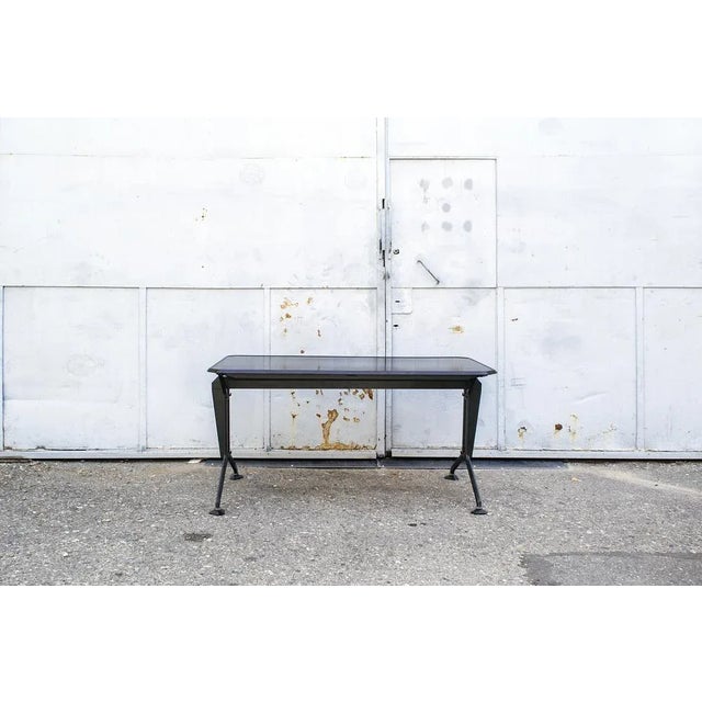 Desk with iron structure, wooden effect polycarbonate top. Arco series by BBPR for Olivetti Synthesis. 1960's. This piece...