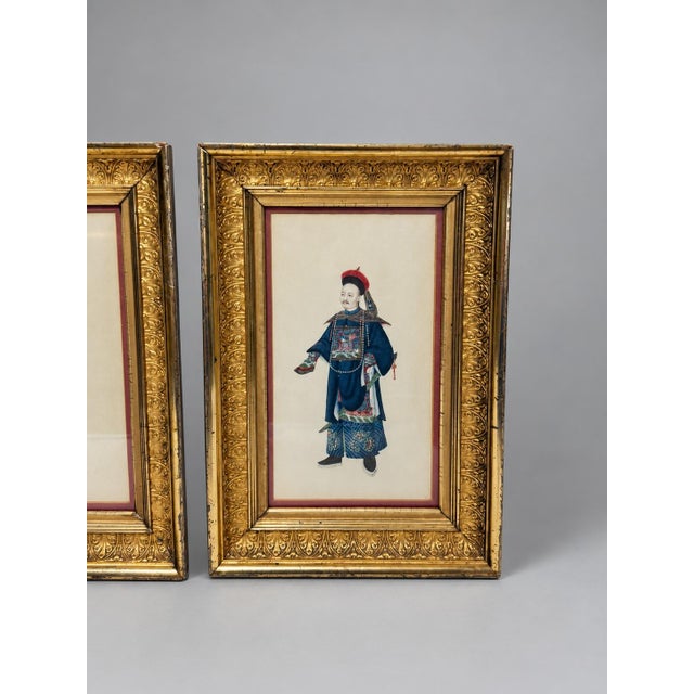 A fine pair of Chinese figural costume lithographs depicting a male court official or mandarin figure and a female figure...
