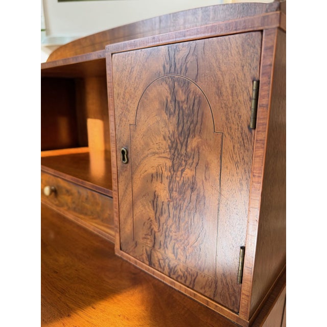 Antique English Secretary Desk Not every desk is about work. This early 20th-century English walnut secretary desk by...