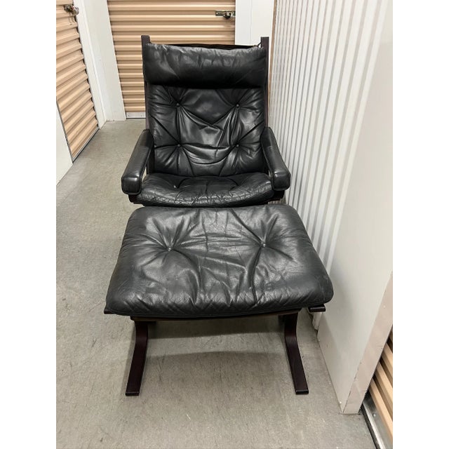 Original Westnofa Siesta Chair & Ottoman. Black leather. In good condition. General wear and tear from use. The ottoman is...