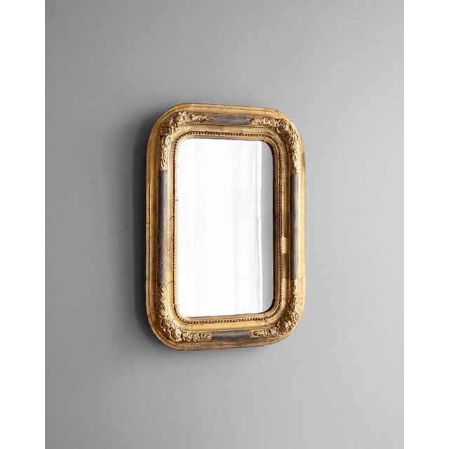 Antique Louis Philippe style wall mirror, from France, second half of the 19th century. The frame has typical rounded...