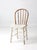 This vintage Windsor bow back chair features a beautifully worn white painted surface with exposed natural wood peeking...