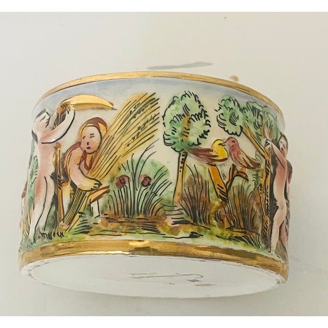 Cute round Italian Capodimonte ceramic trinket box Handpainted with putti and a lid cover. Small repair to the rim cover