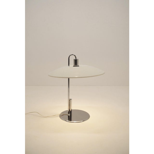 Swedish table lamp designed by Borge Lindau & Bo Lindekrantz in the 1970s. This lamp in chromed steel and painted metal...