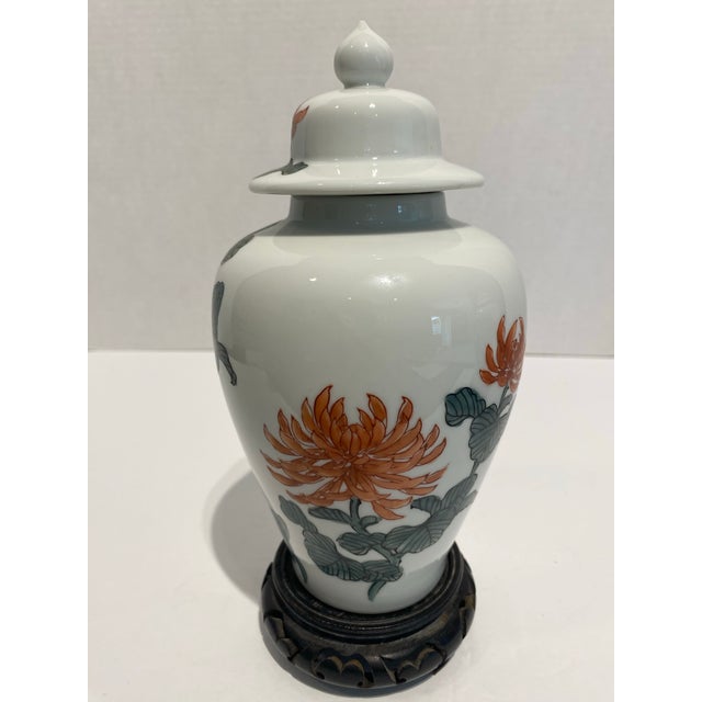This is a pair of unsigned Porcelain Ginger jars with hand painted chrysanthemums over the porcelain. There is a very...