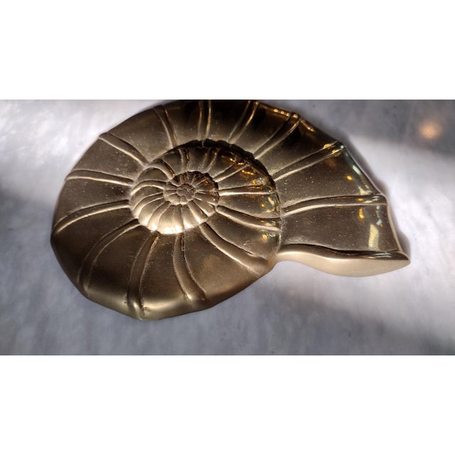 A beautiful vintage brass sea shell wall hanging. This brass wall hanging would make a great standalone gift or work as...