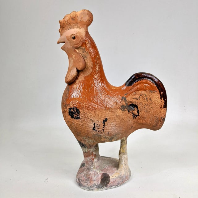 A fun and rustic terracotta rooster that might’ve been used as a roof top tile. It’s in a beautiful orange and brown glaze