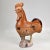 A fun and rustic terracotta rooster that might’ve been used as a roof top tile. It’s in a beautiful orange and brown glaze