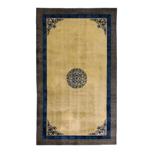 A Beige Ground Highlighted by a Central Round Medallion of Floral Motifs in Deep Indigo Blue.