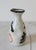 Vintage traditional Japanese tokkuri (sake decanter) crafted from speckled ceramic stoneware and decorated with rustic...