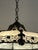Beautiful Victorian Tiffany style chandelier having white milk glass adorned with bronzed metal overlay. 4 bulb sockets...