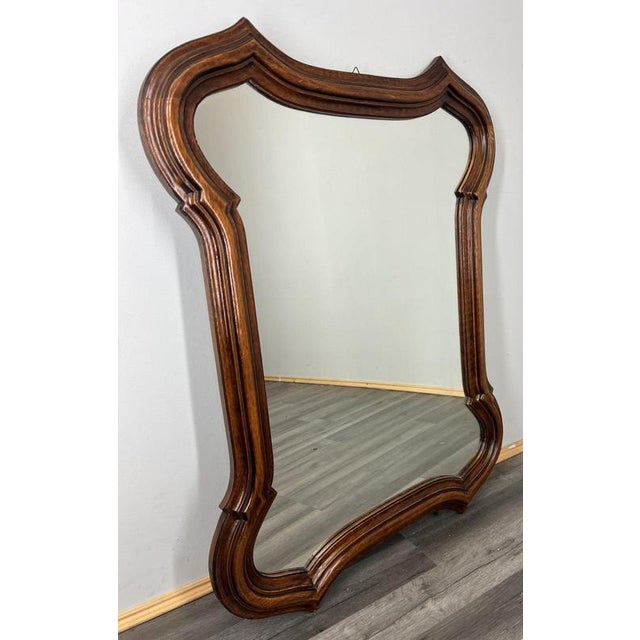 A striking Vintage French mirror with an impressive carved oak frame, designed in a beautifully sculpted silhouette with...