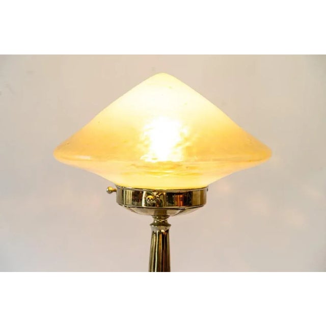 This glass and nickel-plated brass table lamp dates to 1909. European Plug (up to 250V).The wiring of this item may be...