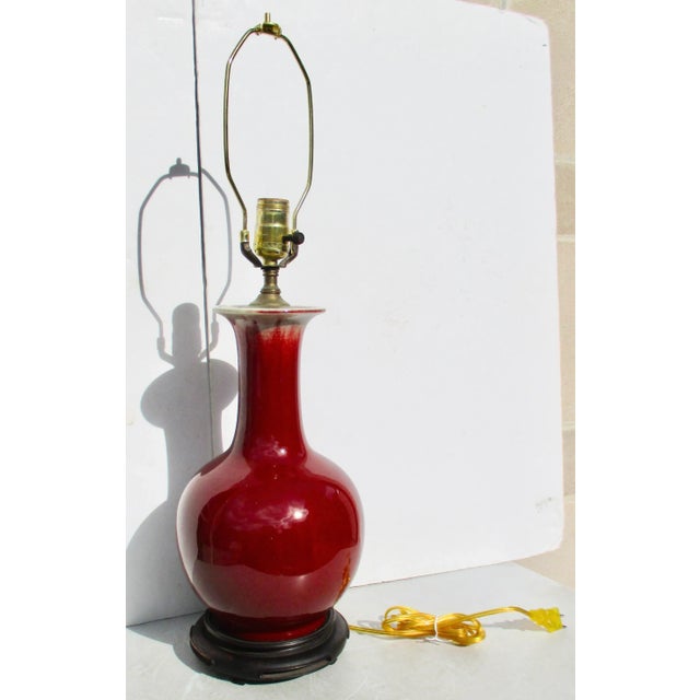 Vintage mid-century Chinese export oxblood glaze bottle vase mounted as a lamp. Wired in the mid-century the vase has a...