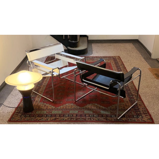 The legendary Wassily Lounge Chair by Marcel Breuer, in black leather, manufactured by Knoll, and in white leather by...