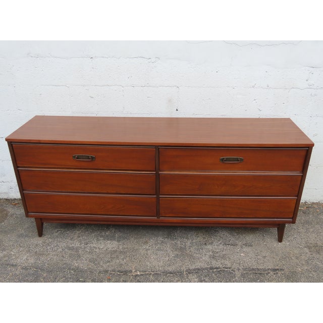 This magnificent Dresser is made of wood, walnut, and veneer. The Dresser was made by Bassett and it is stamped, This...