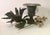 Hand wrought tole floral sculpture sitting tall in a Grecian charcoal gray heavy iron urn. Stem of chippy white bell...