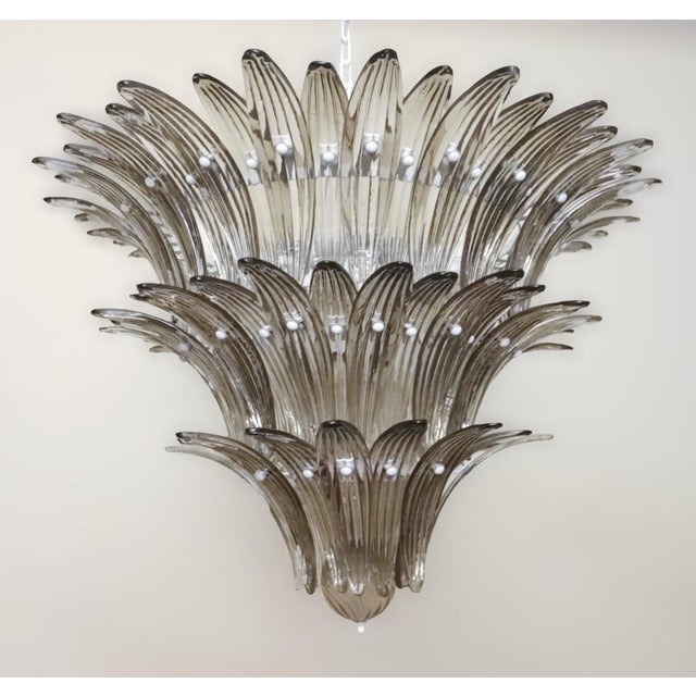 Italian Palmette chandelier with smoky Murano glass leaves arranged in three tiers and mounted on white metal frame / Made...