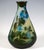 Large teardrop-shaped vase on a flush base, with a narrow opening and flared rim, colourless glass with milky yellow...