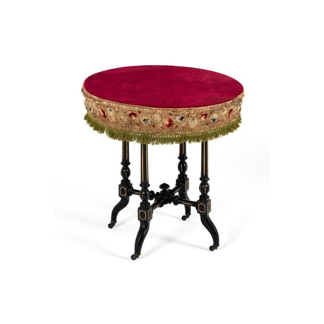 A charming and unusual 19th century Aesthetic Movement gypsy table with a burgundy velvet circular top. Beneath the table...