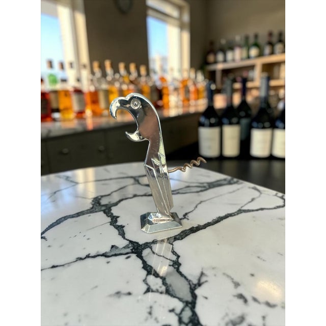 A highly collectible Art Deco chrome-plated parrot bottle opener and corkscrew attributed to Negbaur, produced from Manuel...