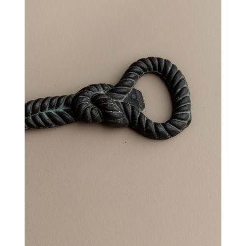 This vintage brass bottle opener from 1960s Italy features a timeless rope and knot design that combines elegance with...