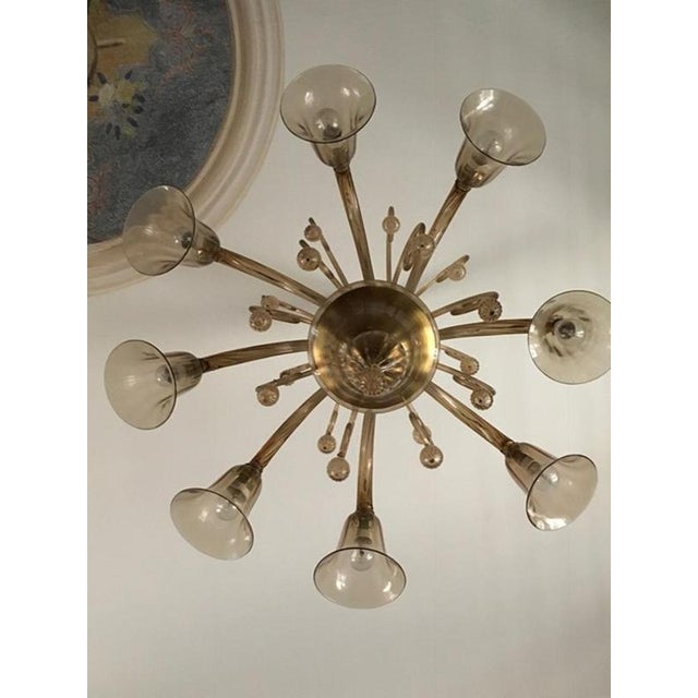 This magnificent and elegant Murano blown glass chandelier has 8 arms, 8 lights and 8 decorative arms. The bulbholders...
