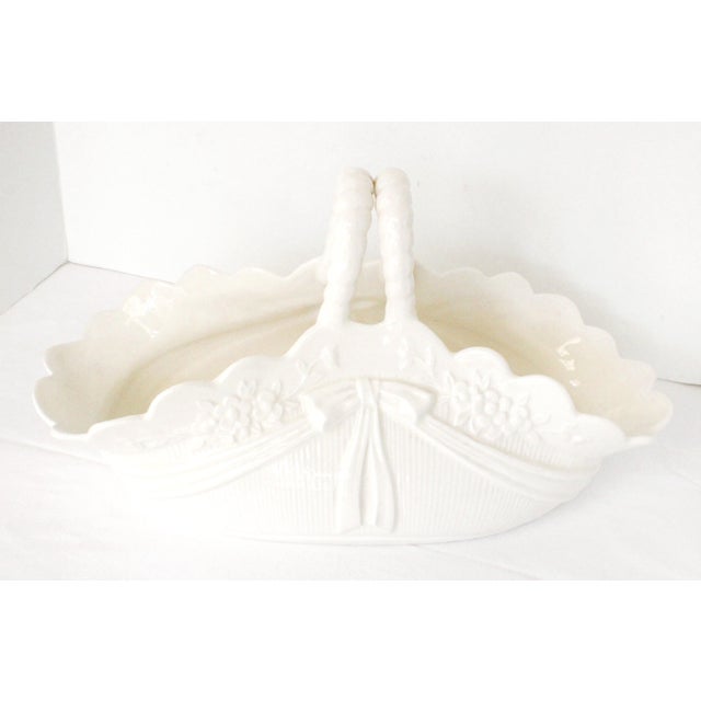 Made in Spain a vintage white embossed ceramic/porcelain centerpiece basket. Featuring a scalloped rim, a dual-wicker...