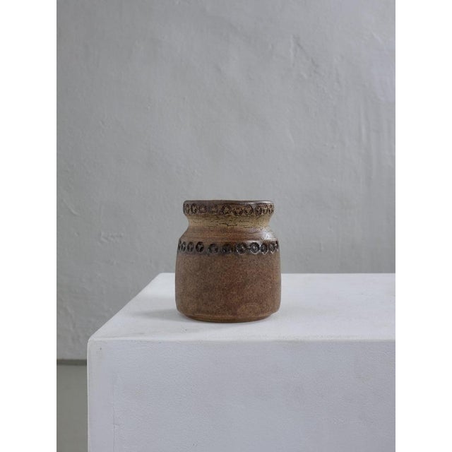 Mid-century stoneware pot designed by Otto Klaesson for Höganäs, Sweden. Crafted in earthy brown glaze with decorative...