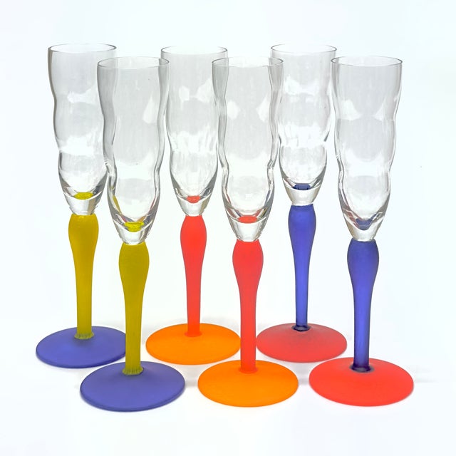 Multi-colored champagne glasses, group of 6. This eccentric 1980s set of stemmed champagne flutes, attributed to Kosta...