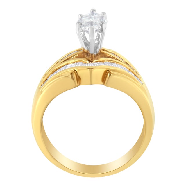 This 14K yellow gold cocktail ring features Baguette diamonds along a V shaped top and bottom rows that perfectly frame a...