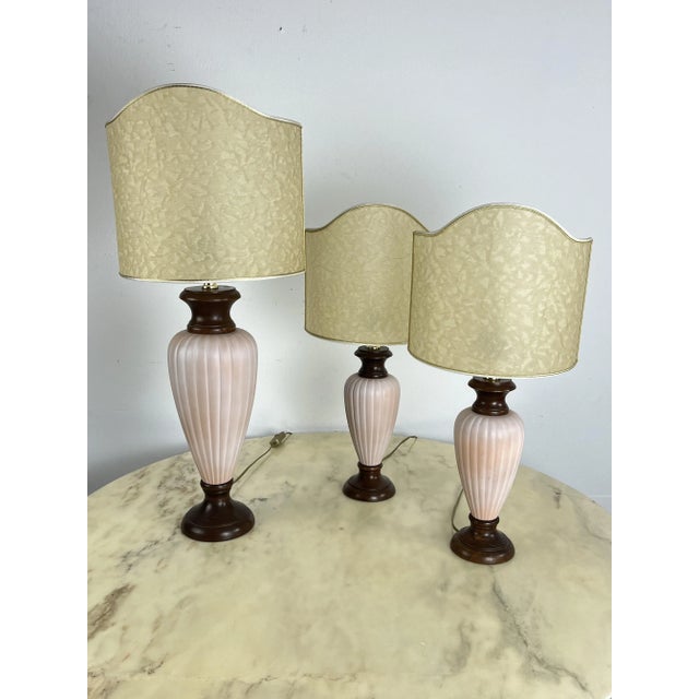 Set of 3 Mid-Century Italian wood and ceramic table lamps from the 1960s. Intact and in good condition. The large one is...
