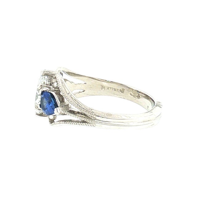 Art Nouveau style ring. The ring features a 0.68 carat marquise-cut white diamond. The diamond has a clarity of SI1 and a...