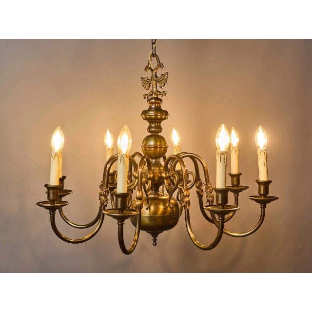 Beautiful flemish chandelier made of patinated brass. The arms are florally decorated. The top part with a flemish eagle....