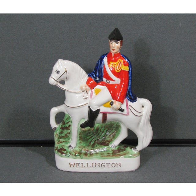 Beautiful Staffordshire-style ceramic figurine of Wellington on horseback, featuring a mounted military figure in a bright...