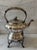 Early 20th century English Sheffield silver plate tilting tea or coffee pot with a matching footed warming stand....