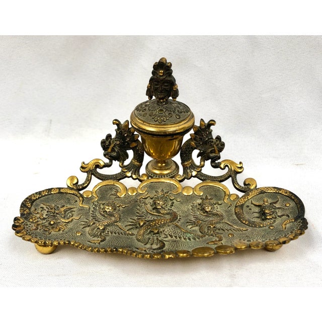 Awesome desk accessory. Brass Asian design intricately embossed inkwell and footed pen tray. Beautiful scalloped edge. The...