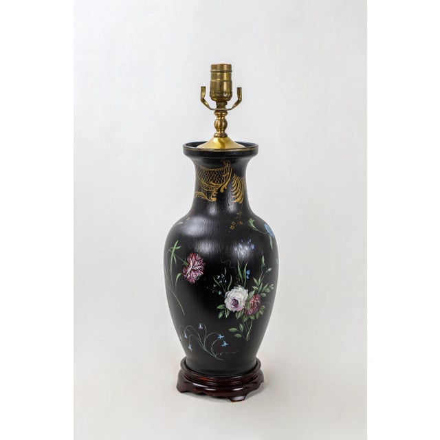Vintage porcelain vase lamp painted black with colorful blooms of assorted flowers. Along with some gold color detailing...