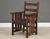 A rare L&JG Stickley Onondaga captain’s dining chair constructed of quarter sawn oak and a leather seat. Original finish....