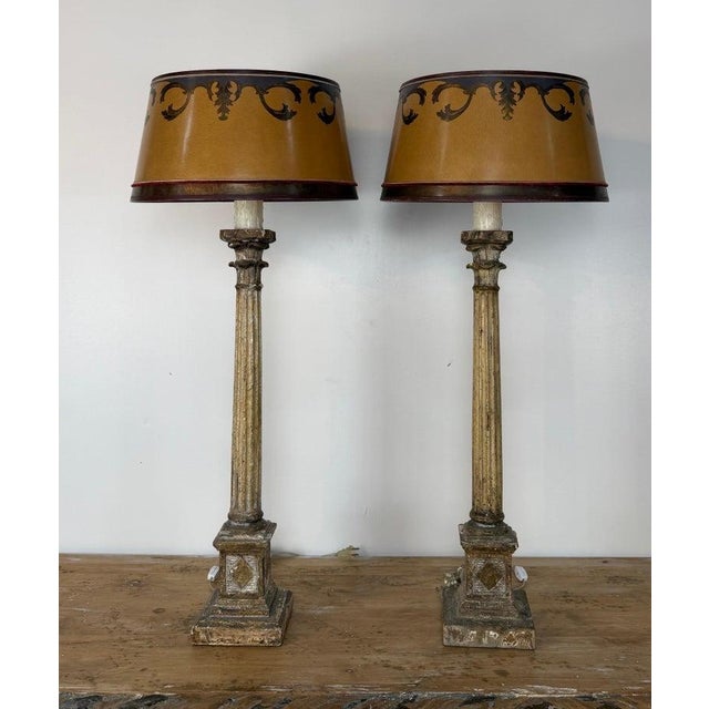 An exceptionally atmospheric and highly collectible pair of vintage Italian Neoclassical column table lamps, rendered as...