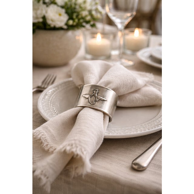 A vintage swedish napkin ring by gab (guldsmedsaktiebolaget), circa 1960s, crafted in alpaca and decorated with a charming...