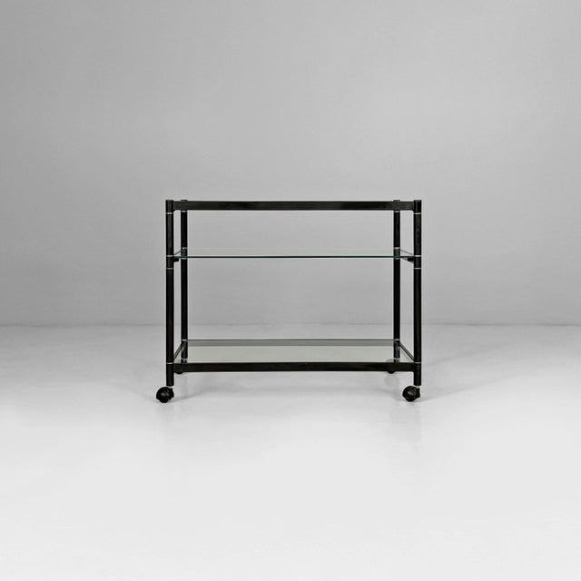 Italian modern cart in steel and glass, 1970s Cart with a rectangular matte black painted metal frame and three clear...